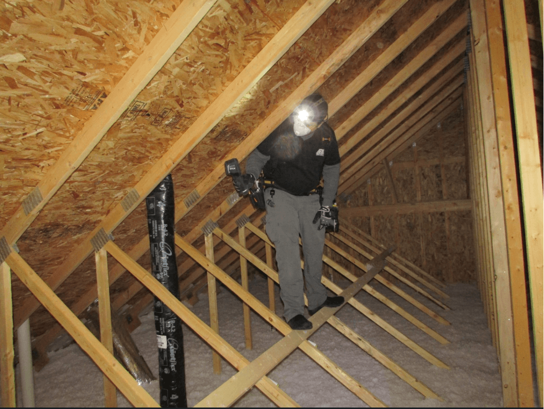 Inspector examining attic during a home inspection